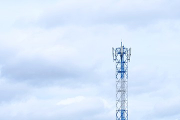 Telecommunication tower with cloudy background.