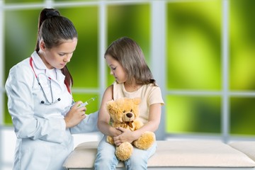 Young woman doctor with little girl