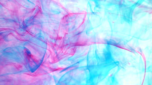 An abstract background of slow moving blue and pink dye ink under the water