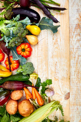 Fresh colorful organic vegetables from above. Top view, flat lay. Different vegetables for eating healthy on wooden background. Clean eating food frame. Copy space. Vegetarian, vegan..