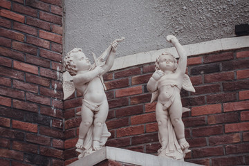 Cupid angel sculpture of European church with wings