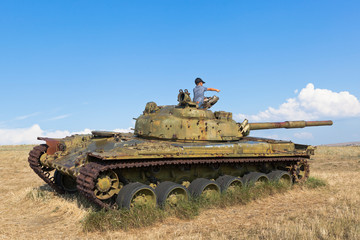 Boy plays on the T-64 tank in the Ataman ethnographic complex. Taman Temryuk district of the...