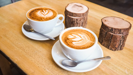 Latte art drawing on a milk foam, cappuccino coffee in the cafe  