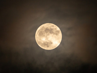 Naklejka na ściany i meble Full moon on the dark night shining on the sky in cloudy day.