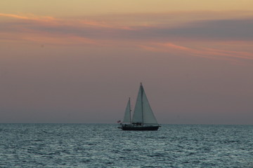 Fototapeta na wymiar sailboat sailing after sunset
