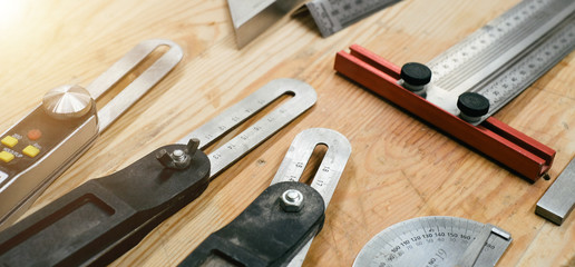 Workshop scene. Measurement Tools on wooden table in workshop, Tool shelf set in garage style - obrazy, fototapety, plakaty