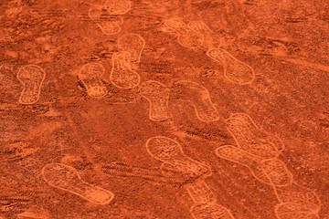 Footprints on a clay tennis court