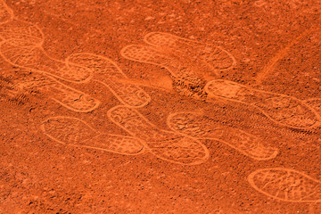 Footprints on a clay tennis court