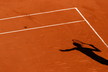 A tennis Clay court and the shadow of a player  - 284143029
