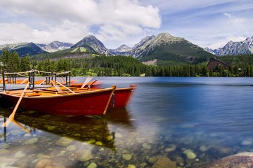 Fototapeta na wymiar Red bouats on lake in the High Tatras