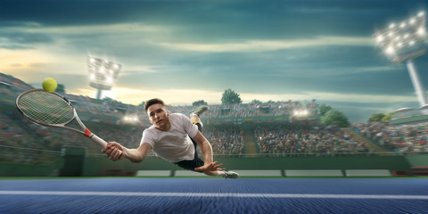 Male athlete plays tennis on a professional court