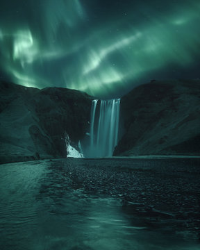 Northern lights over Skogafoss waterfall, Iceland