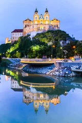 Fototapeten Melk Abbey, German: Stift Melk, reflected in the water of Danube River by night, Wachau Valley, Austria © pyty