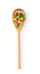 Spoon with fresh arugula and vegetables on white background