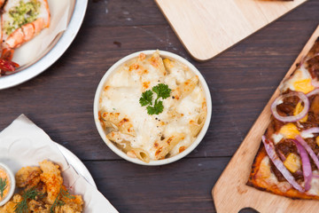 Baked pasta penne with broccoli smoked pork neck mozzarela cheese and othe ingredients.