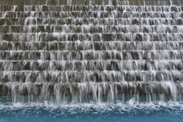 Water flowing down multi level fountain