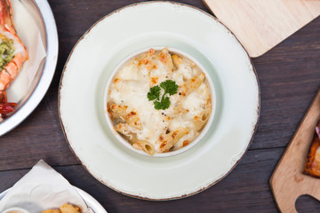 Baked pasta penne with broccoli smoked pork neck mozzarela cheese and othe ingredients.