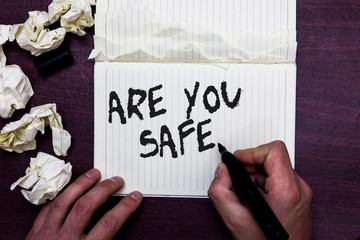 Word writing text Are You Safe. Business concept for Free from danger Not anticipating any Harm Hurt physically Man holding marker notebook page crumpled papers several tries mistakes