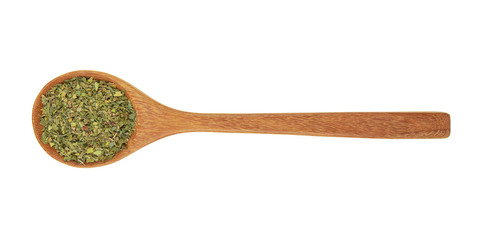 dried parsley in wooden spoon isolated on white background.