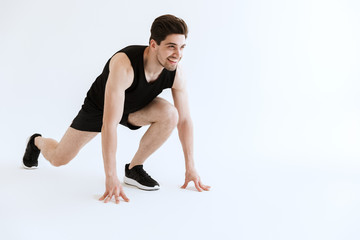 Obraz premium Attractive fit young sportsman standing isolated