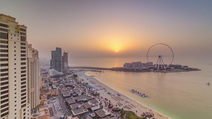 Sunset waterfront overview Jumeirah Beach Residence JBR skyline aerial timelapse with yacht and boats