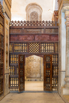 Interleaved wooden wall, known as mashrabiya, with wooden ornate door