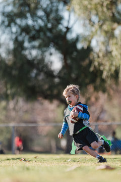 Boy playing flag football, California, United States