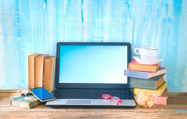 workspace of a creative person, books, laptop, smartphone, creativity business mockup, good copy space