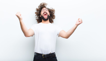 young man with crazy hair in motion celebrating his success