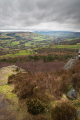 Dramatic moody Winter landscape image of Peak District in England during soft afternoon light