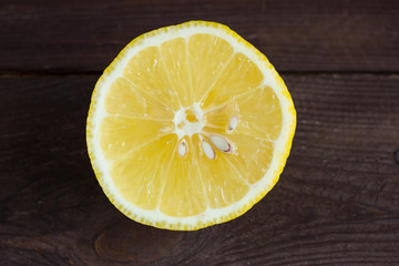 Lemon slices on a dark wooden background