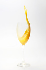 splash of orange juice in the glass on white background
