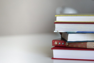 Open book on wood desk in the library room with blurred focus for background, education back to school concept, vintage color tone process