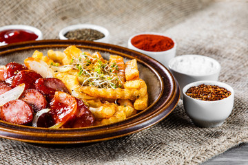 Grilled sausages, French fries and vegetables