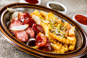 Grilled sausages, French fries and vegetables