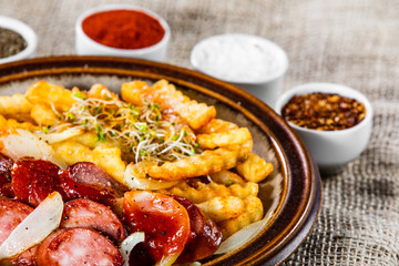Grilled sausages, French fries and vegetables
