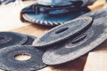 circles for the angle grinder are on wooden boards near the grinder.