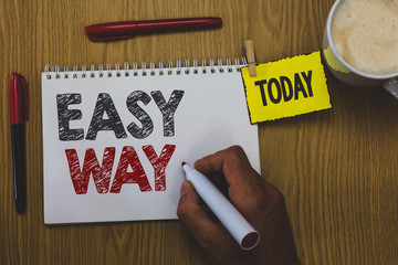 Word writing text Easy Way. Business concept for making hard decision between two less and more effort method Man holding marker notebook wooden table for today important coffee cup