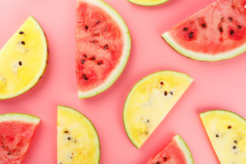 Juicy slices of red watermelon on a bright pink background. Conceptual colors of summer. Patterns top view as a background or substrate