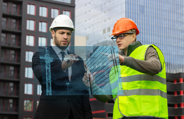 engineer and builder hologram discuss drawing new technologies virtual  business