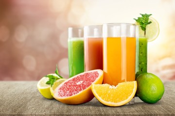 Tasty fruits and juice on wooden table