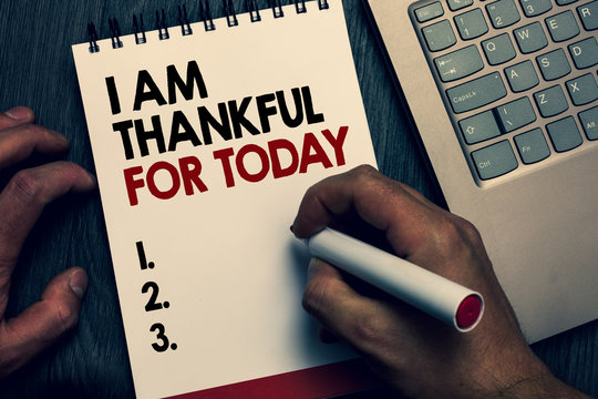 Text sign showing I Am Thankful For Today. Conceptual photo Grateful about living one more day Philosophy Written words and number on notepad man hold marker keyboard on wooden desk