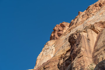Fototapeta na wymiar Capitol Reef National Park low angle landscape of barren colorful stone cliff 