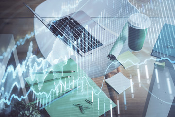 Financial market graph hologram and personal computer on background. Multi exposure. Concept of forex.