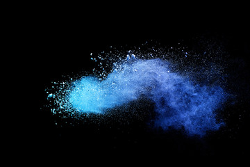 Blue powder explosion on black background. Colored cloud. Colorful dust explode. Paint Holi.