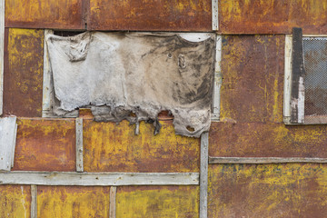old rusty iron background with torn burlap