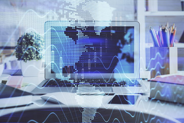 Forex market chart hologram and personal computer background. Double exposure. Concept of investment.