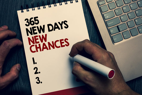 Text sign showing 365 New Days New Chances. Conceptual photo Starting another year Calendar Opportunities Written words and number on notepad man hold marker keyboard on wooden desk