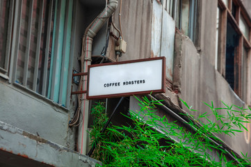 Horizontal side view of empty black signage on business skyscraper with modern architecture and glass windows
