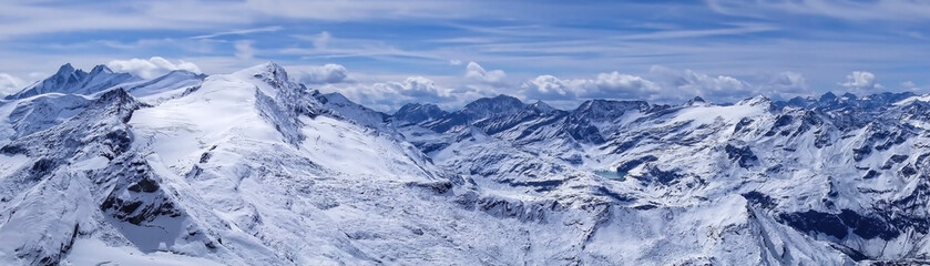Alpine Austrian mountains covered with snow. Beautiful panorama of high snowy mountains in Austria